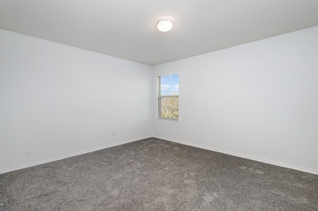 empty room featuring dark colored carpet