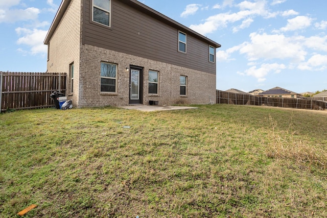 back of property featuring a yard and a patio