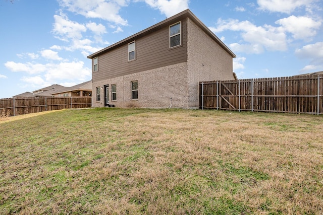 back of property featuring a lawn