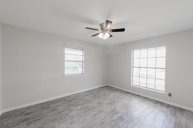 spare room featuring hardwood / wood-style floors and ceiling fan