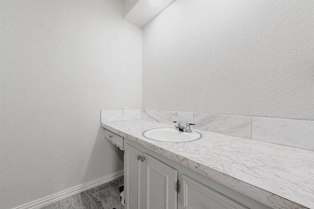 bathroom with vanity and wood-type flooring