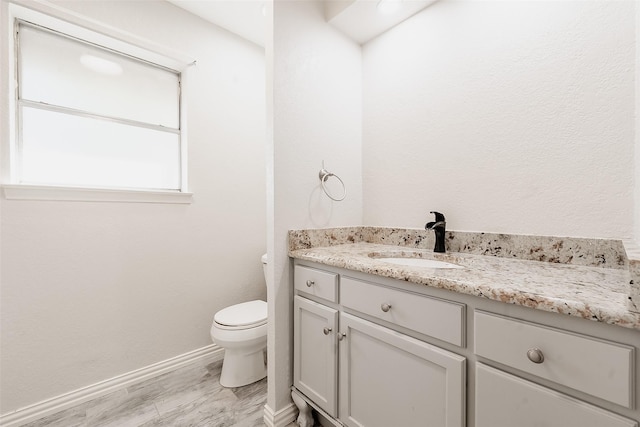 bathroom featuring hardwood / wood-style flooring, vanity, and toilet