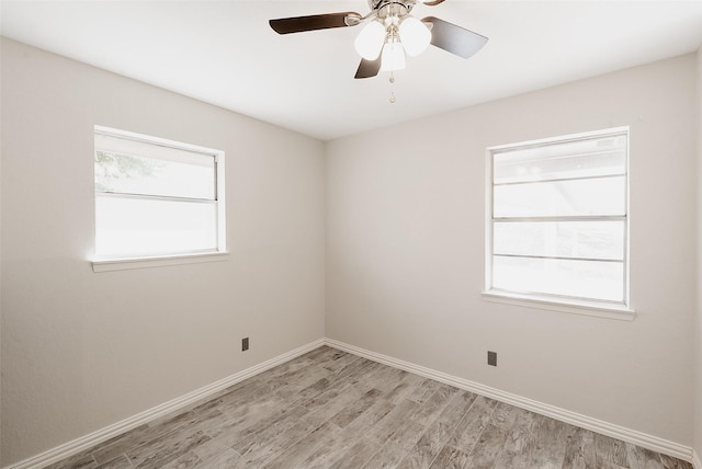 spare room featuring ceiling fan, plenty of natural light, and light hardwood / wood-style flooring