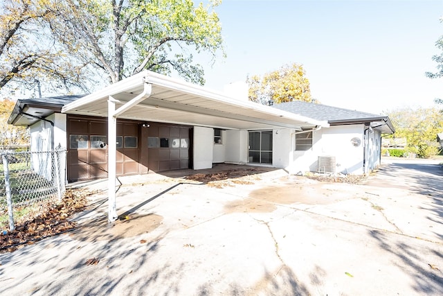 back of property featuring a carport