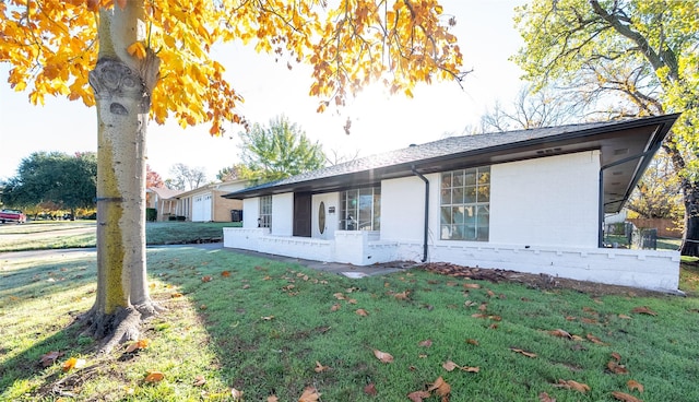 view of side of property with a yard