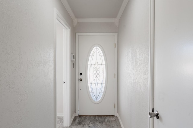 doorway with light wood-type flooring and ornamental molding