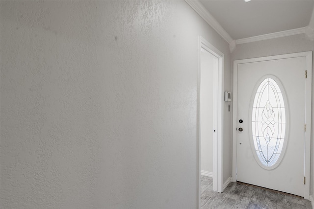 entryway with light hardwood / wood-style floors and crown molding