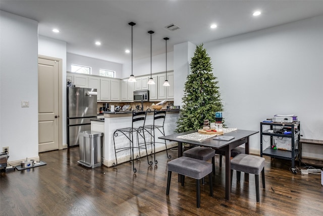 dining space featuring dark wood-type flooring