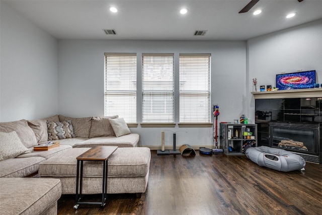 living room featuring dark hardwood / wood-style floors and ceiling fan