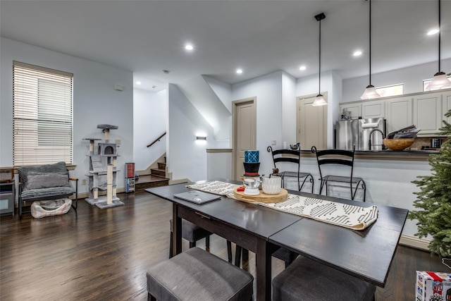 dining room with a wealth of natural light and dark wood-type flooring