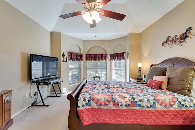 carpeted bedroom featuring a textured ceiling and ceiling fan