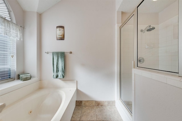 bathroom featuring tile patterned flooring, a textured ceiling, and shower with separate bathtub