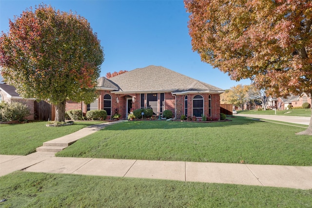 single story home featuring a front lawn