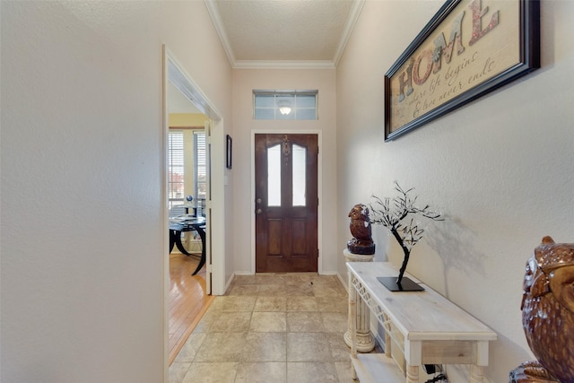 interior space featuring a textured ceiling, light hardwood / wood-style flooring, and crown molding