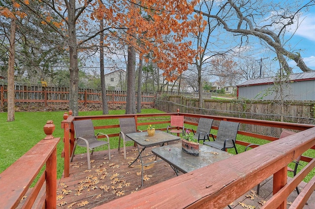 wooden deck featuring a yard