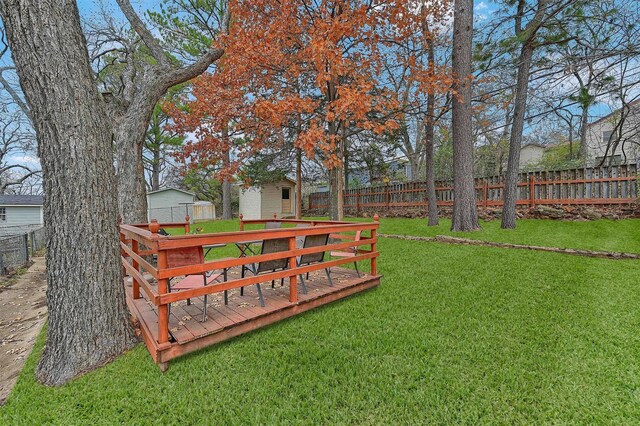 view of yard with a storage unit and a wooden deck