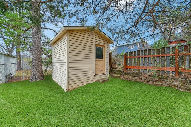 view of outbuilding with a yard