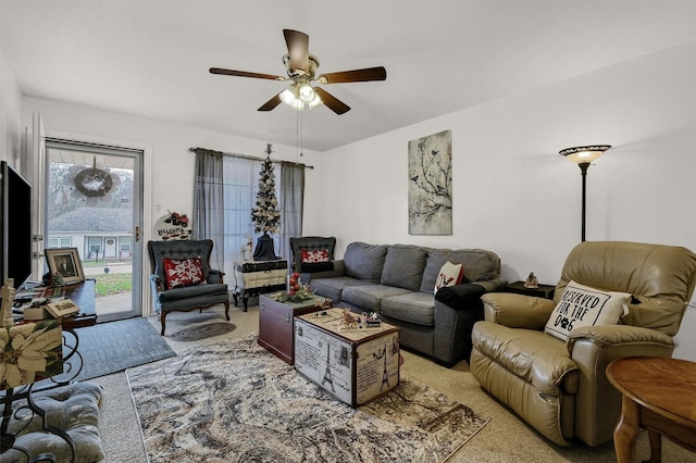 carpeted living room with ceiling fan