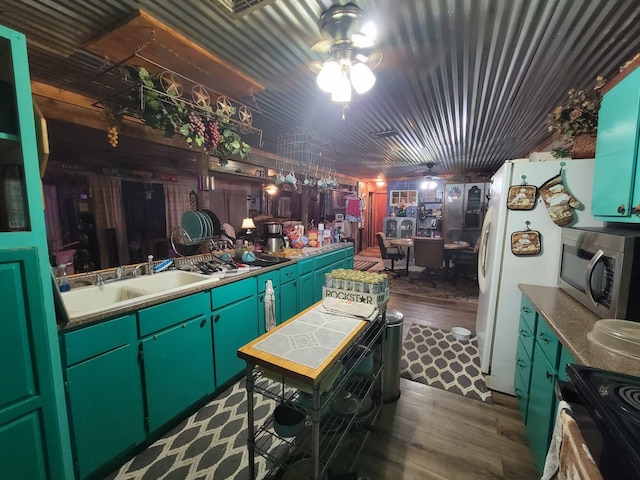 kitchen with dark hardwood / wood-style flooring, black range with electric cooktop, ceiling fan, sink, and white fridge