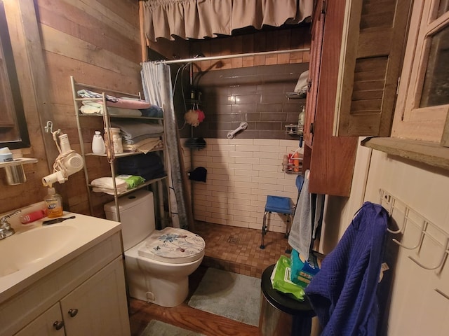 bathroom with tile patterned floors, toilet, curtained shower, and wooden walls