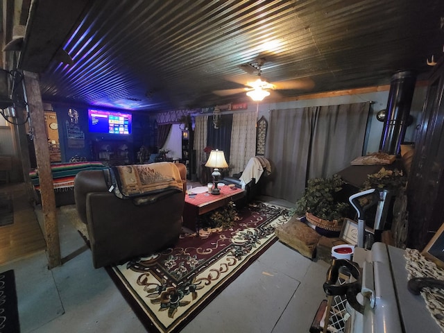 living room with ceiling fan and concrete flooring