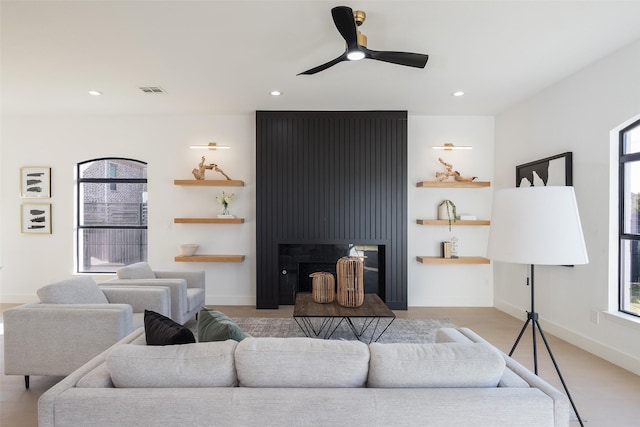 living room with ceiling fan and a wealth of natural light