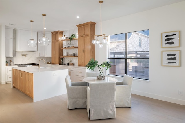 dining room featuring sink and light wood-type flooring