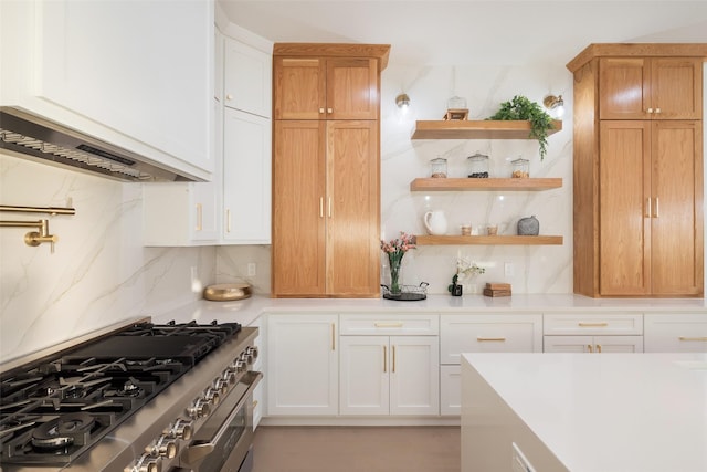 kitchen featuring backsplash, stainless steel stove, and white cabinets