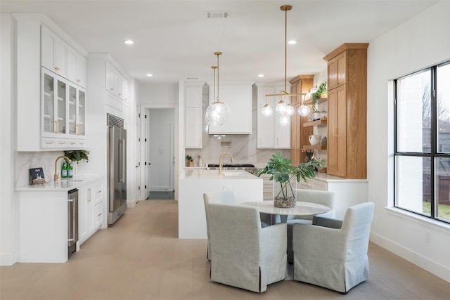 dining space featuring sink and beverage cooler