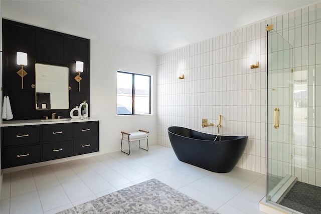 bathroom featuring tile patterned flooring, vanity, separate shower and tub, and tile walls