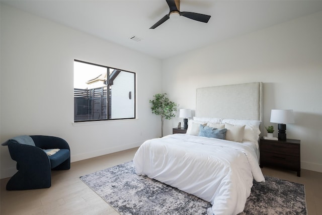 bedroom with ceiling fan and light hardwood / wood-style floors