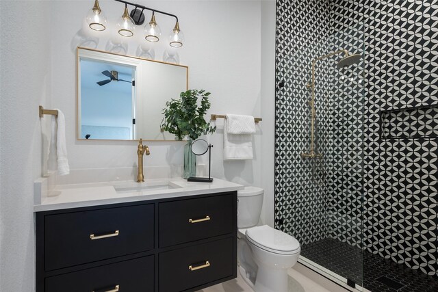 bathroom featuring vanity, toilet, and a shower with door