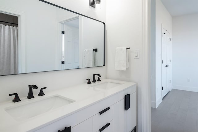 bathroom featuring vanity and wood-type flooring