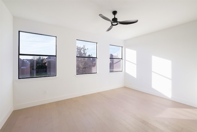 spare room featuring ceiling fan and light wood-type flooring