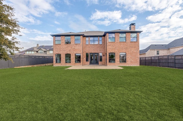 rear view of property featuring a patio and a lawn