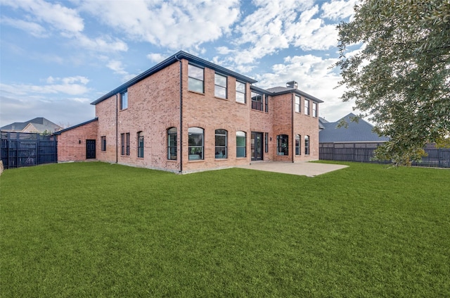 rear view of house featuring a yard and a patio area