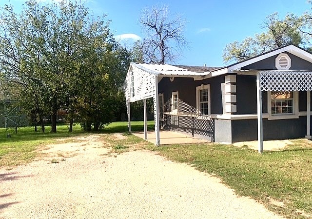 view of side of property with a lawn