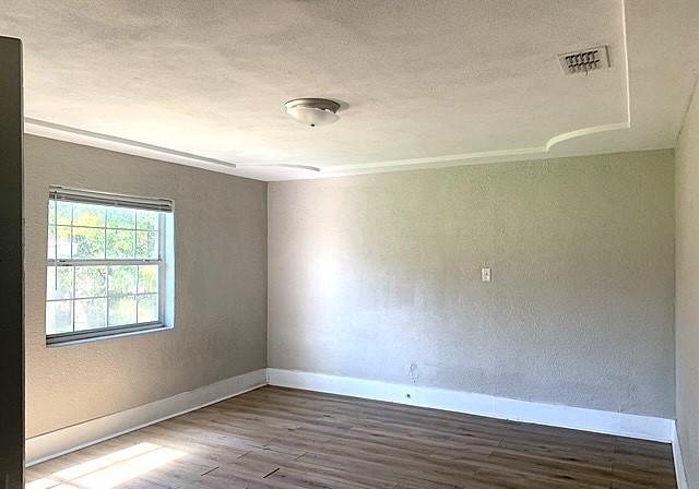 unfurnished room featuring hardwood / wood-style flooring