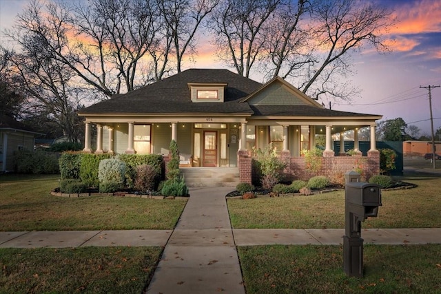 view of front facade with a yard and a porch