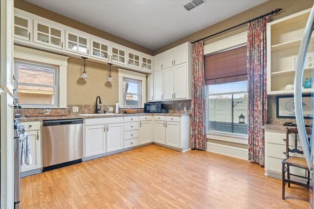 kitchen featuring dishwasher, pendant lighting, light wood-type flooring, and white cabinets