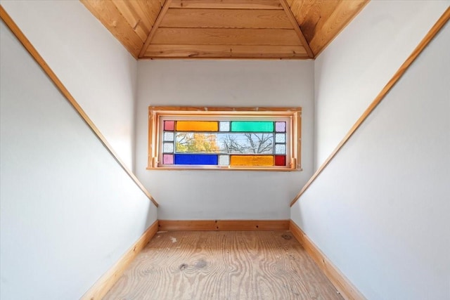 stairs featuring wooden ceiling and lofted ceiling