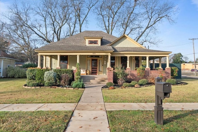 view of front of property featuring covered porch and a front lawn