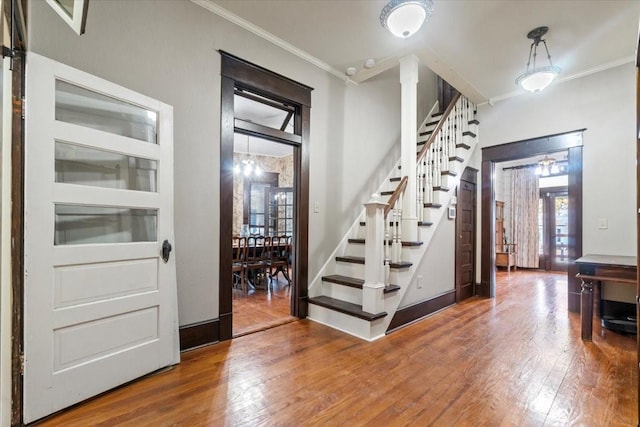 entryway featuring hardwood / wood-style flooring and crown molding