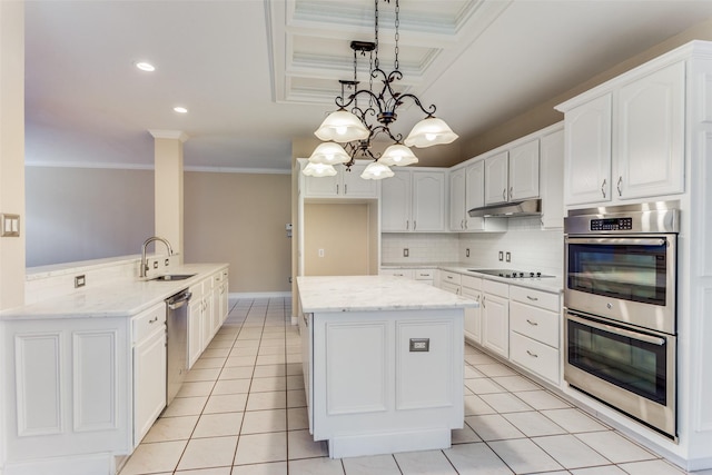 kitchen with kitchen peninsula, sink, decorative light fixtures, white cabinetry, and stainless steel appliances