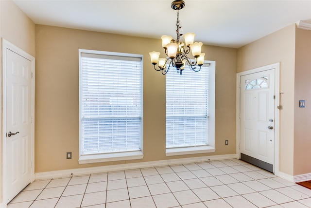 foyer with light tile patterned floors and an inviting chandelier