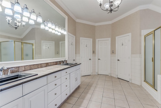 bathroom featuring an enclosed shower, ornamental molding, and a chandelier