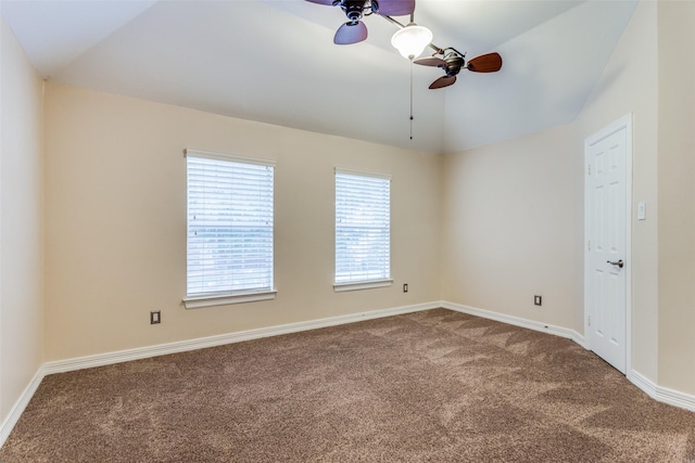 spare room featuring carpet flooring, ceiling fan, and vaulted ceiling