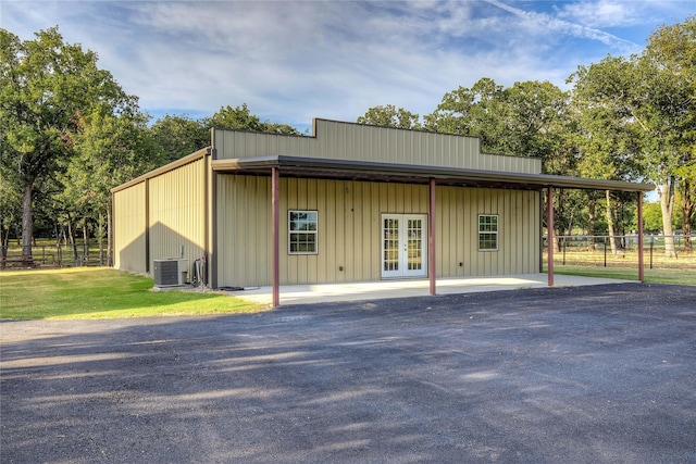 view of outbuilding featuring central AC and french doors