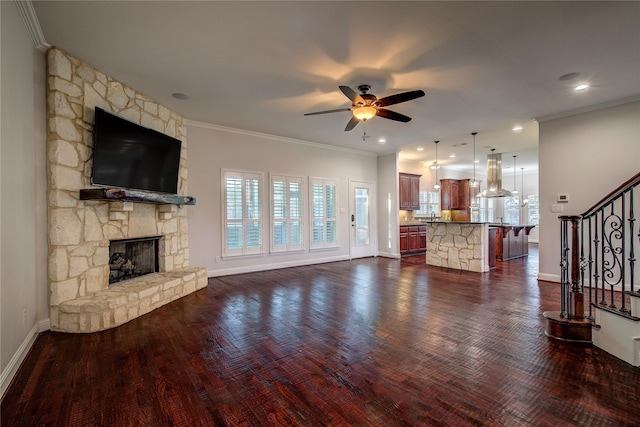 4676 County Road 2230, Caddo Mills, TX 75135 - unfurnished living room featuring a ceiling fan, a fireplace, stairs, crown molding, and baseboards