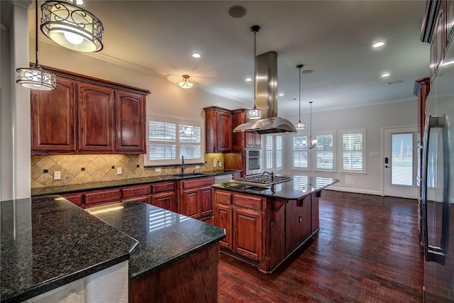 kitchen with sink, island range hood, a center island, hanging light fixtures, and appliances with stainless steel finishes